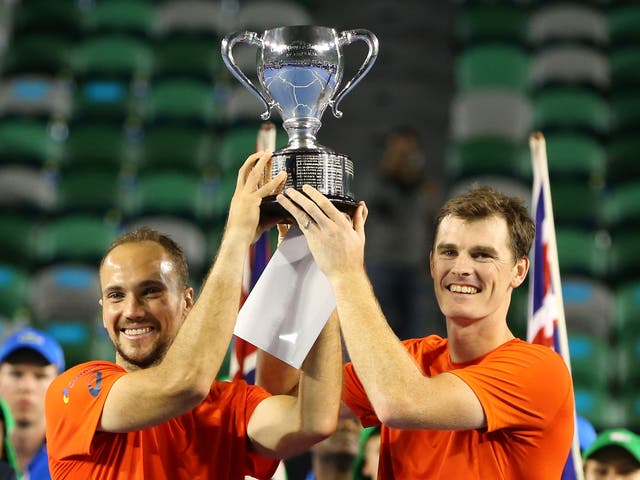 Jamie Murray of Great Britain and Bruno Soares of Brazil pose with the trophy