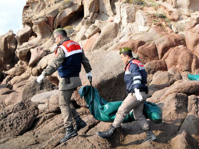 Turkish officers carry the body of a refugee who drowned during a failed attempt to sail to the Greek island in the coastal town of Bademli, in Canakkale, Turkey, 30 January 2016.