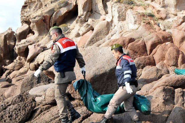 Turkish officers carry the body of a refugee who drowned during a failed attempt to sail to the Greek island in the coastal town of Bademli, in Canakkale, Turkey, 30 January 2016.