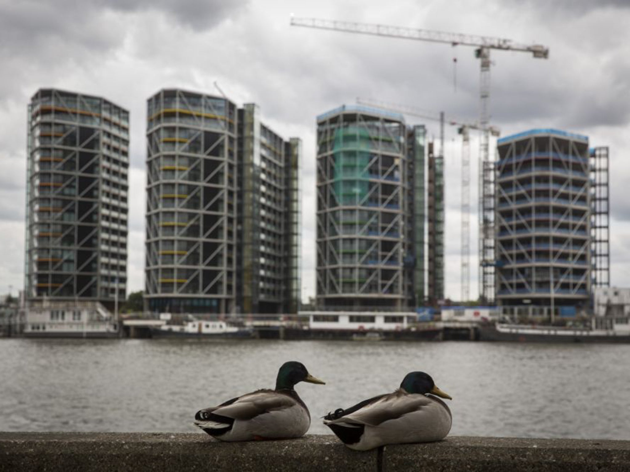 Luxury flats go up by the Thames. New figures show that property prices are booming, the average home in the capital is now worth £500,000 and the prices are being driven up