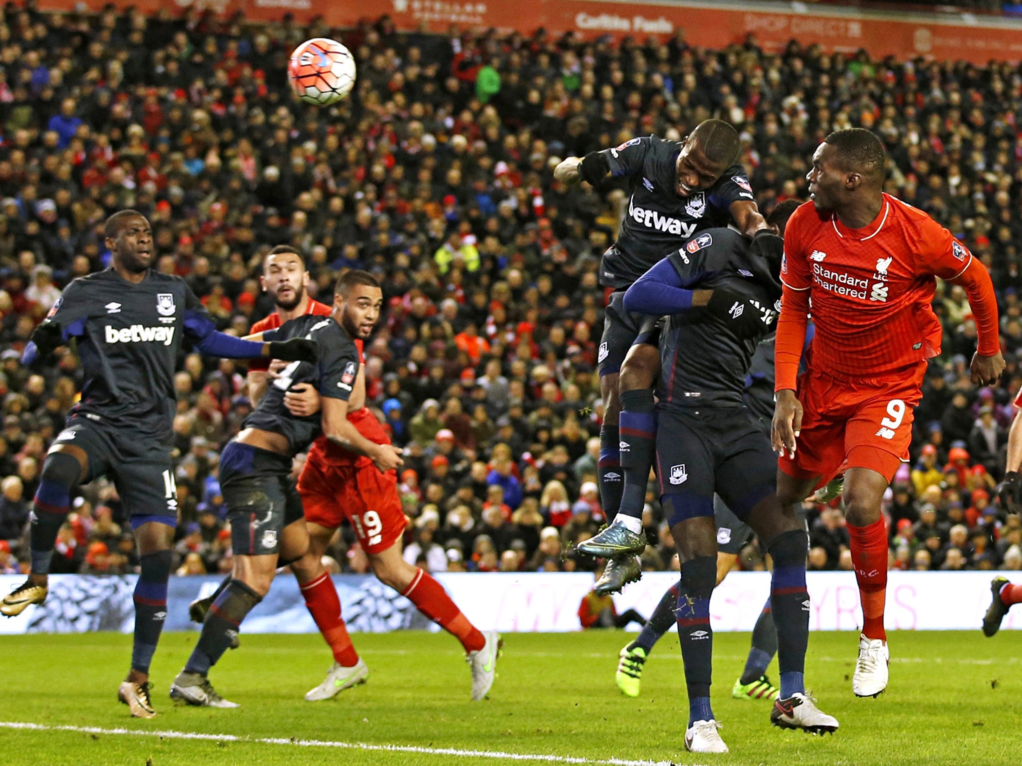 Liverpool striker Christian Benteke heads at goal