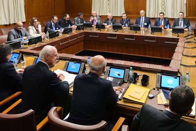 Staffan de Mistura (2nd L Below) faces Syrian ambassador to the UN and head of the government delegation Bashar al-Jaafari (4th R Above) at the opening of Syrian peace talks with the Syrian government delegation at the United Nations (UN) Offices in Geneva on January 29, 2016.
 FABRICE COFFRINI/AFP/Getty Images