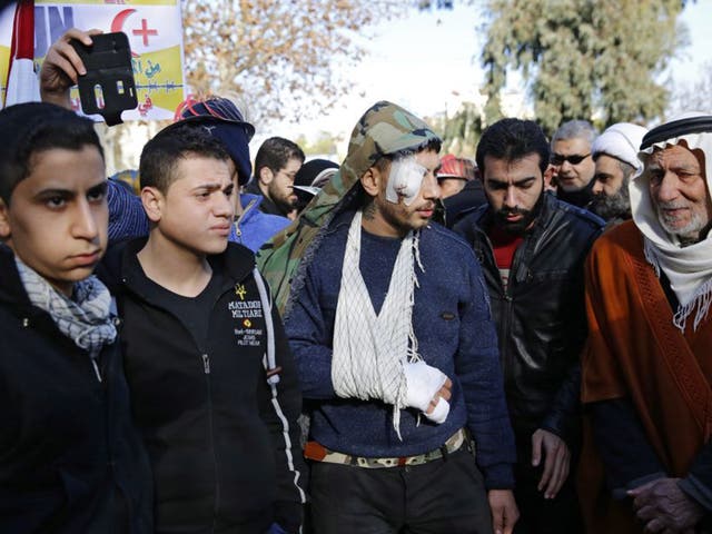 Evacuees from Syrian towns at a Damascus rally