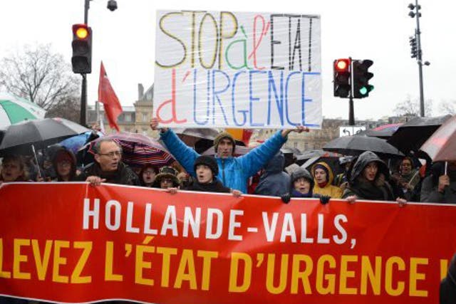 Thousands of protesters marched in the Paris rain to call on the French government to end the state of emergency