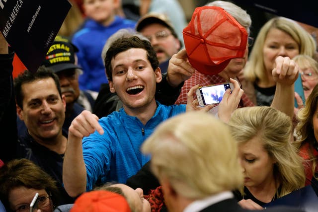 Supporters rush to meet Mr Trump at a rally in Clinton, Iowa