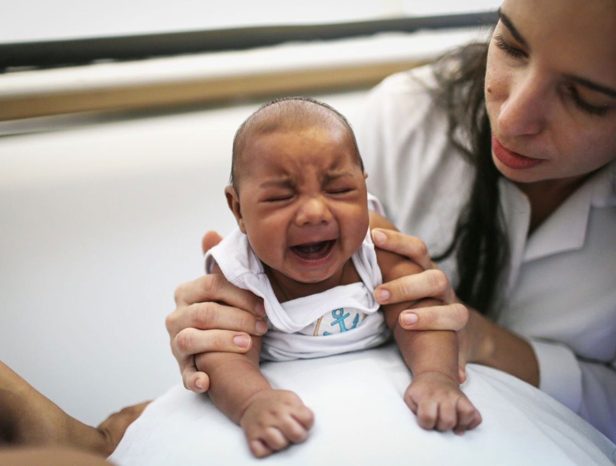 Dr. Valeria Barros treats a 6-week old baby born with microcephaly at the Lessa de Andrade polyclinic during a physical therapy session on January 29, 2016 in Recife, Pernambuco state, Brazil.