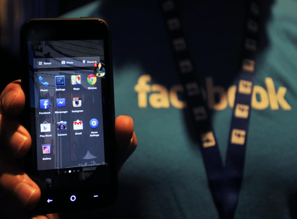 A Facebook employee holds an HTC phone running the social network's ill-fated 'Home' mobile operating system in 2013