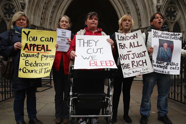 Demonstrators protesting against government changes to the welfare system and the proposed 'Bedroom Tax' outside the High Court in 2013