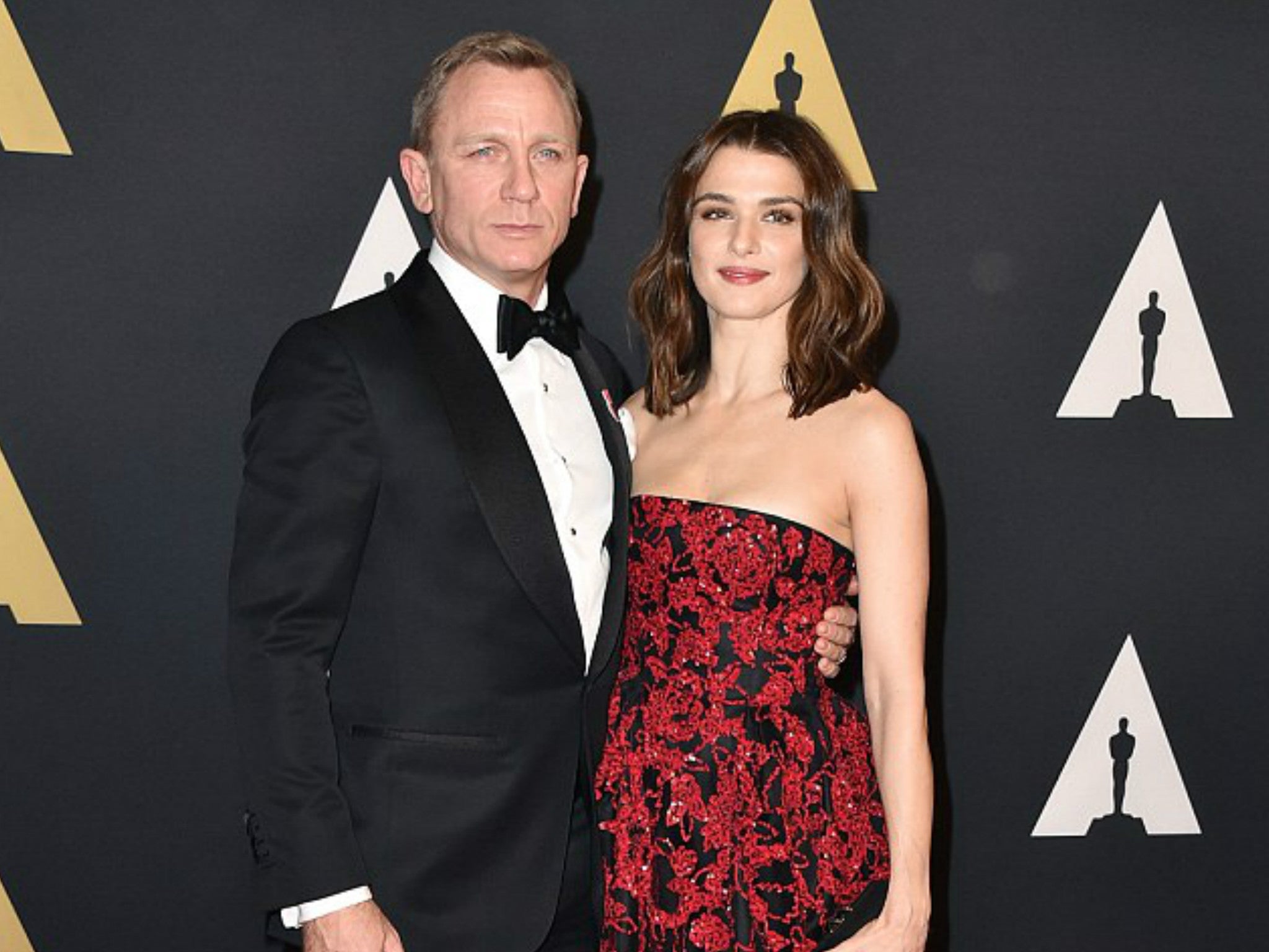 Daniel Craig, dressed in the GOSH tuxedo lot, poses on the red carpet with Rachel Weisz at the Governors Awards in Hollywood last November