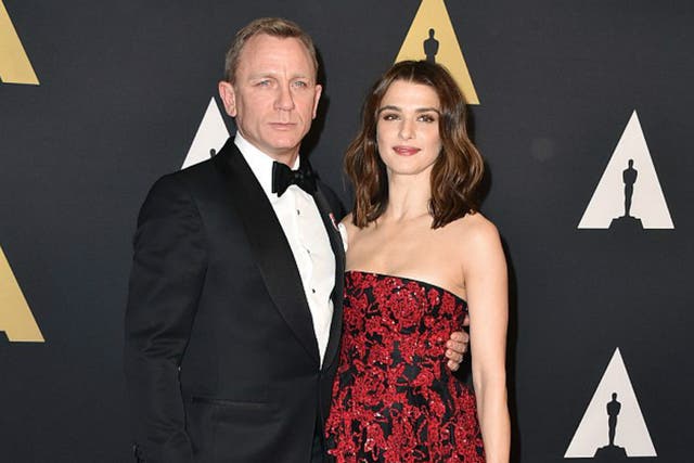 Daniel Craig, dressed in the GOSH tuxedo lot, poses on the red carpet with Rachel Weisz at the Governors Awards in Hollywood last November