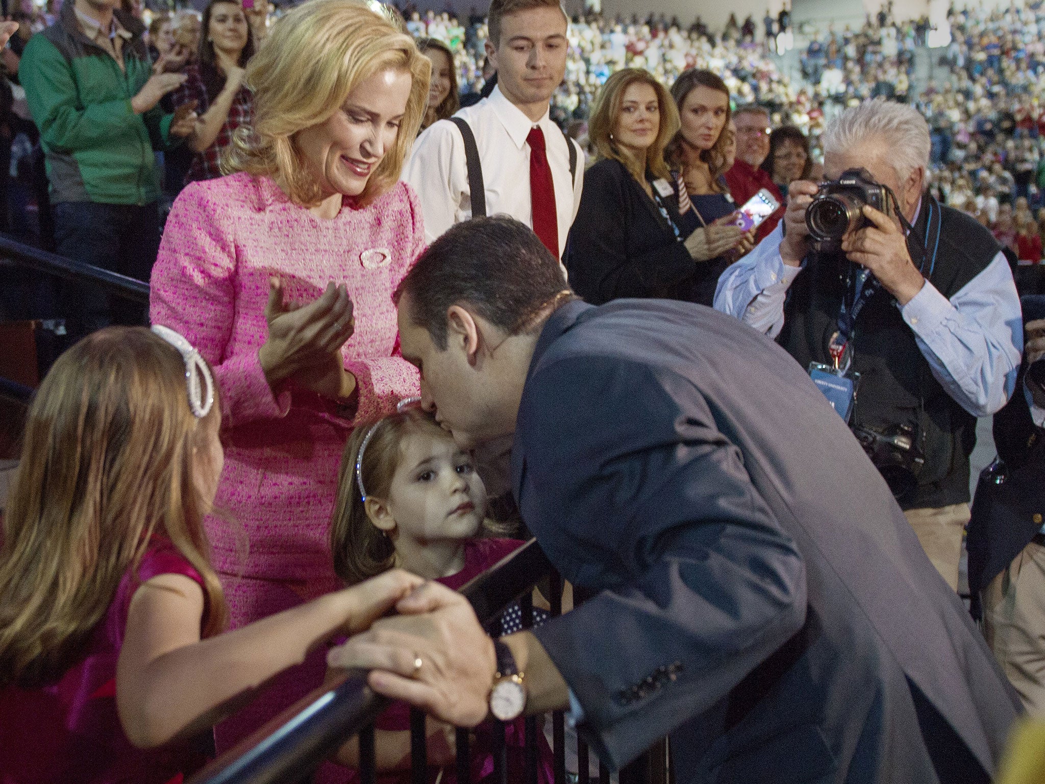Ted Cruz greets his wife Heidi and daughters Caroline (R) and Catherine (C) before taking the stage announce his candidacy for the Republican nomination to run for US President March 23, 2015