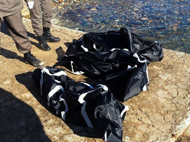 Turkish police officers stand next to the dead bodies of migrants in Seferihisar near Izmir, Turkey, Tuesday, Feb. 2, 2016.