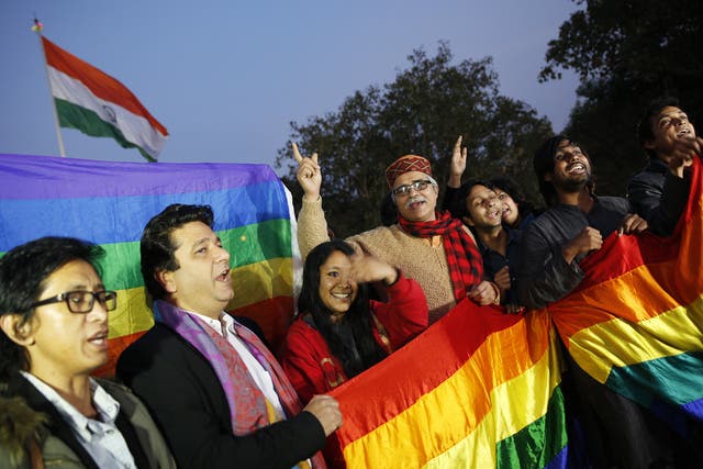 Gay rights supporters celebrate after India's top court agreed to re-examine a colonial-era law that criminalises homosexual acts