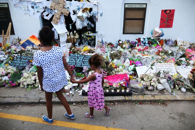Children look on the memorial after the shooting that look nine lives in Charleston, South Carolina.