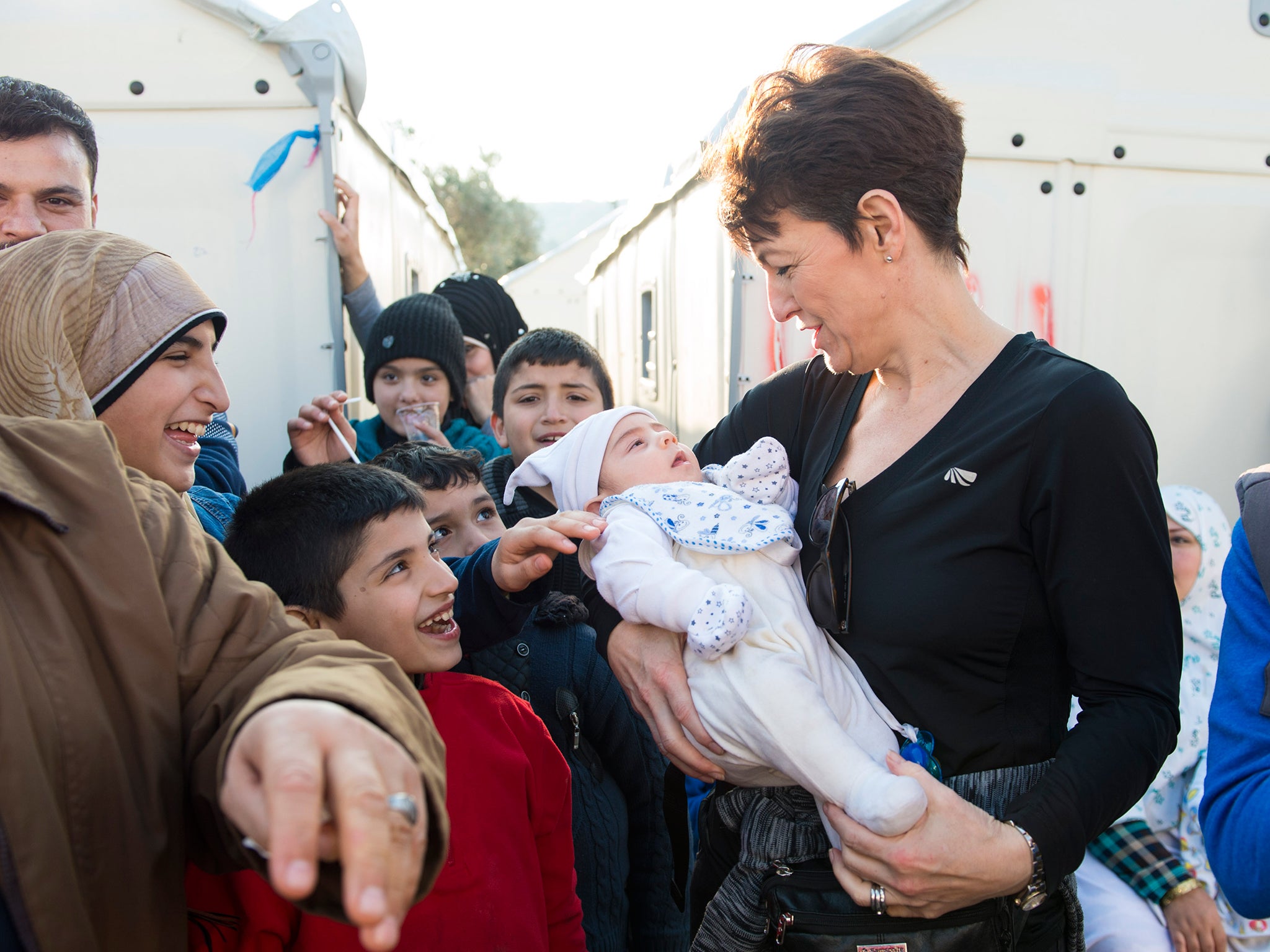 Jo Churchill holds a baby during the visit (Matt Crossick/Save The Children)