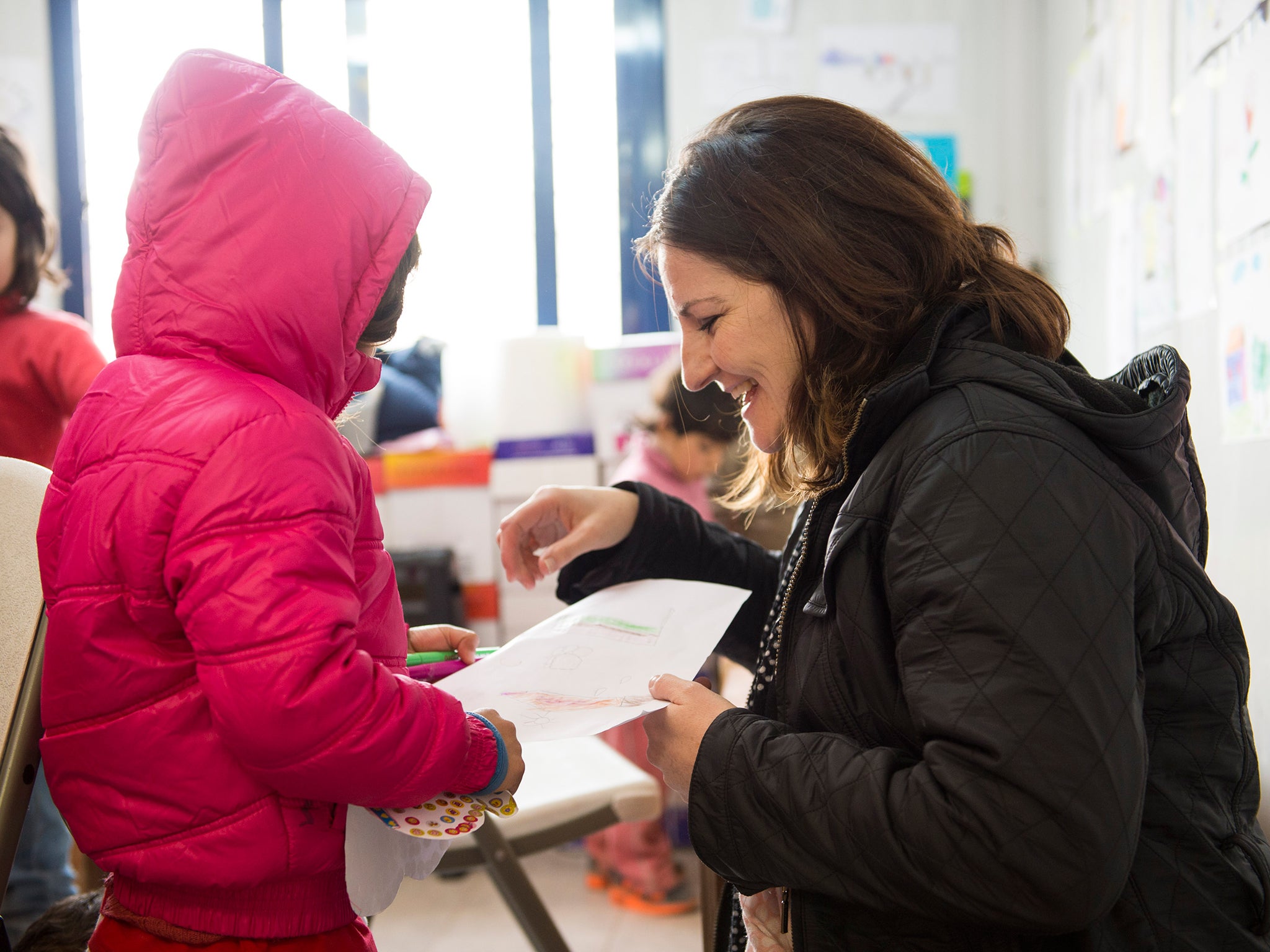 Caroline Ansell chats to a Syrian refugee in Save the Children's Child Friendly Space at Kara Tepe (Matt Crossick/Save The Children)