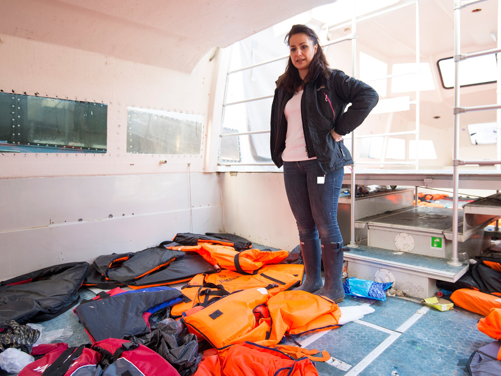 Conservative MP Heidi Allen looks at life jackets used by refugees aboard a boat in Mytilene harbour, on the Greek island of Lesbos (Save The Children)