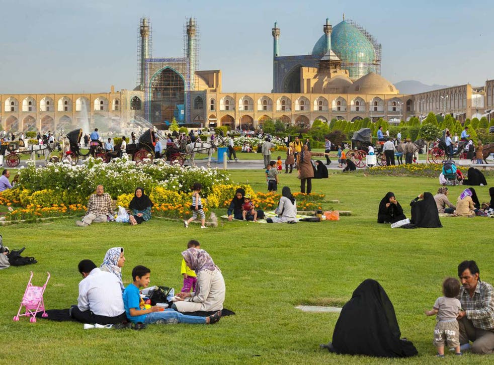 Iranian families picknicking in Naqsh-e Jahan Square, in the city of Isfahan
