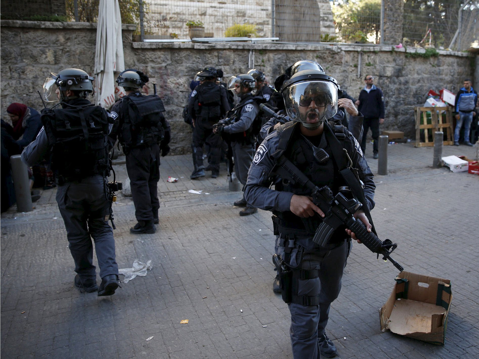 Israeli police secure an area near the scene where three Palestinians were shot dead by Israeli police