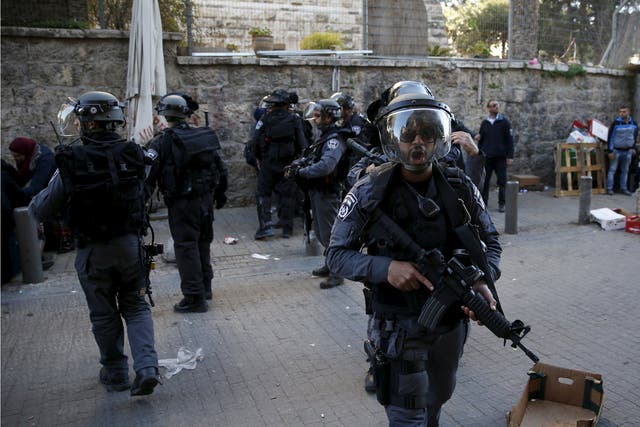 Israeli police secure an area near the scene where three Palestinians were shot dead by Israeli police