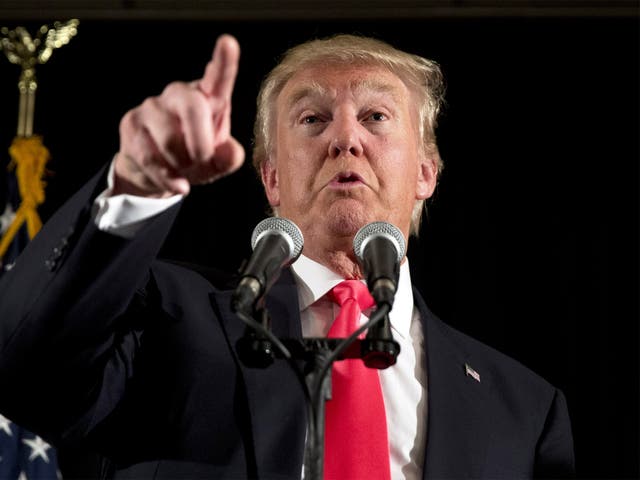 Donald Trump makes a point to reporters during a news conference in Milford, New Hampshire