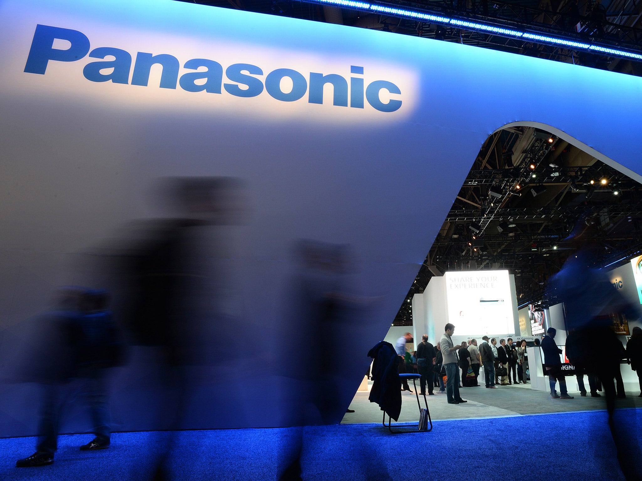 Attendees walk past the Panasonic booth at the International CES in Las Vegas