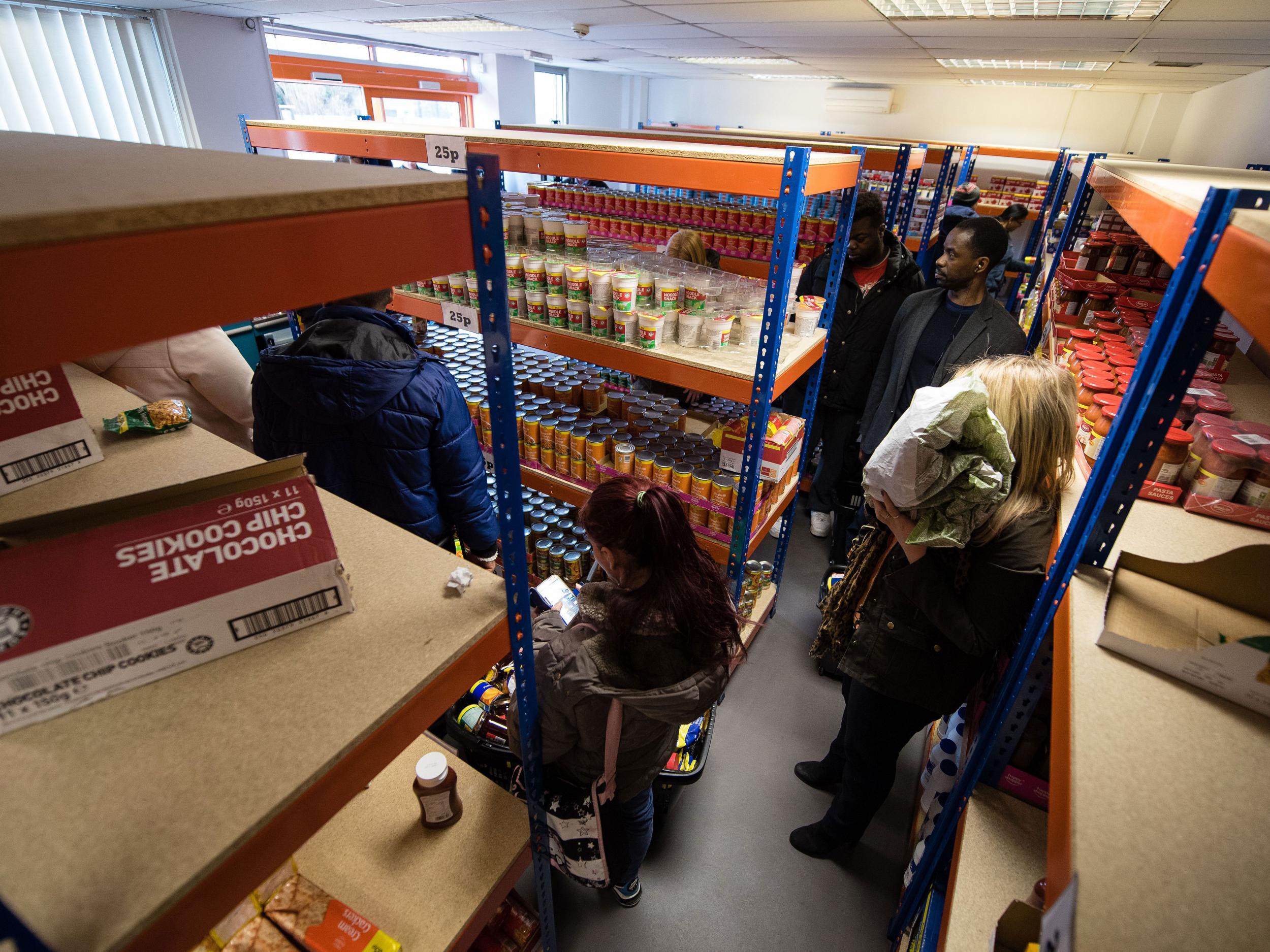 Shoppers queue to pay for their goods at the 'easyFoodstore' in north-west London