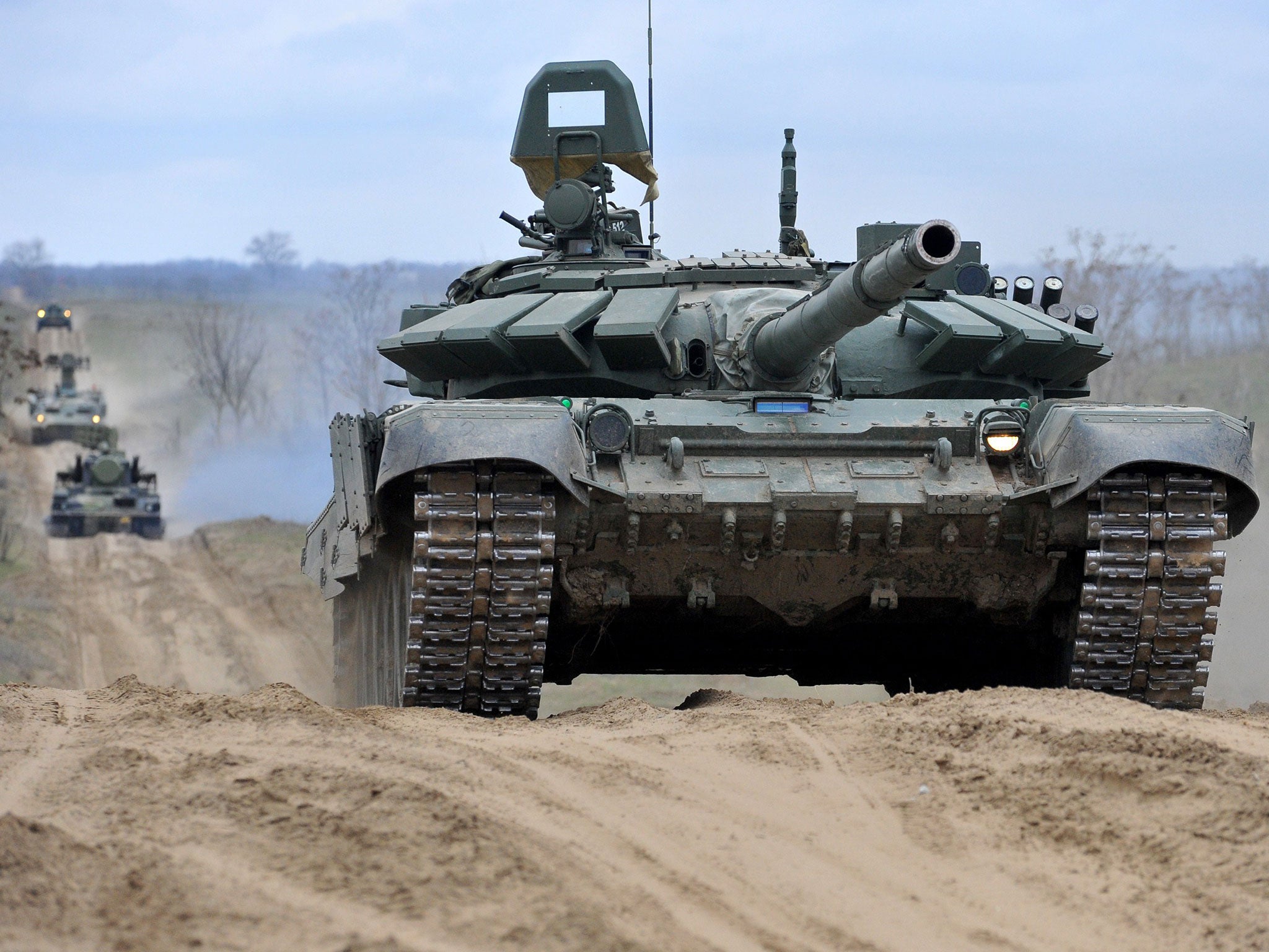 Russian tanks and military troops take part in a military drill