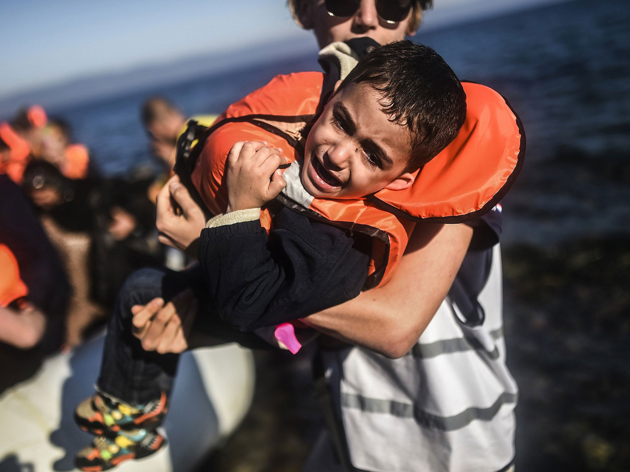 Refugees, many of whom started their journey in Syria, arrive in Lesbos from Turkey