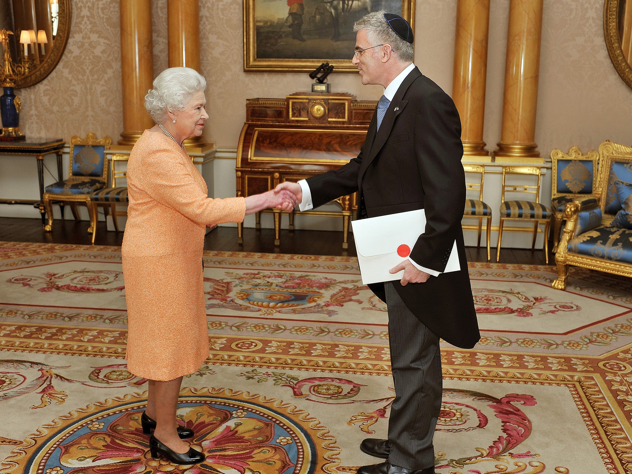 Queen Elizabeth II shakes hands with the ambassador of Israel Daniel Taub in 2011