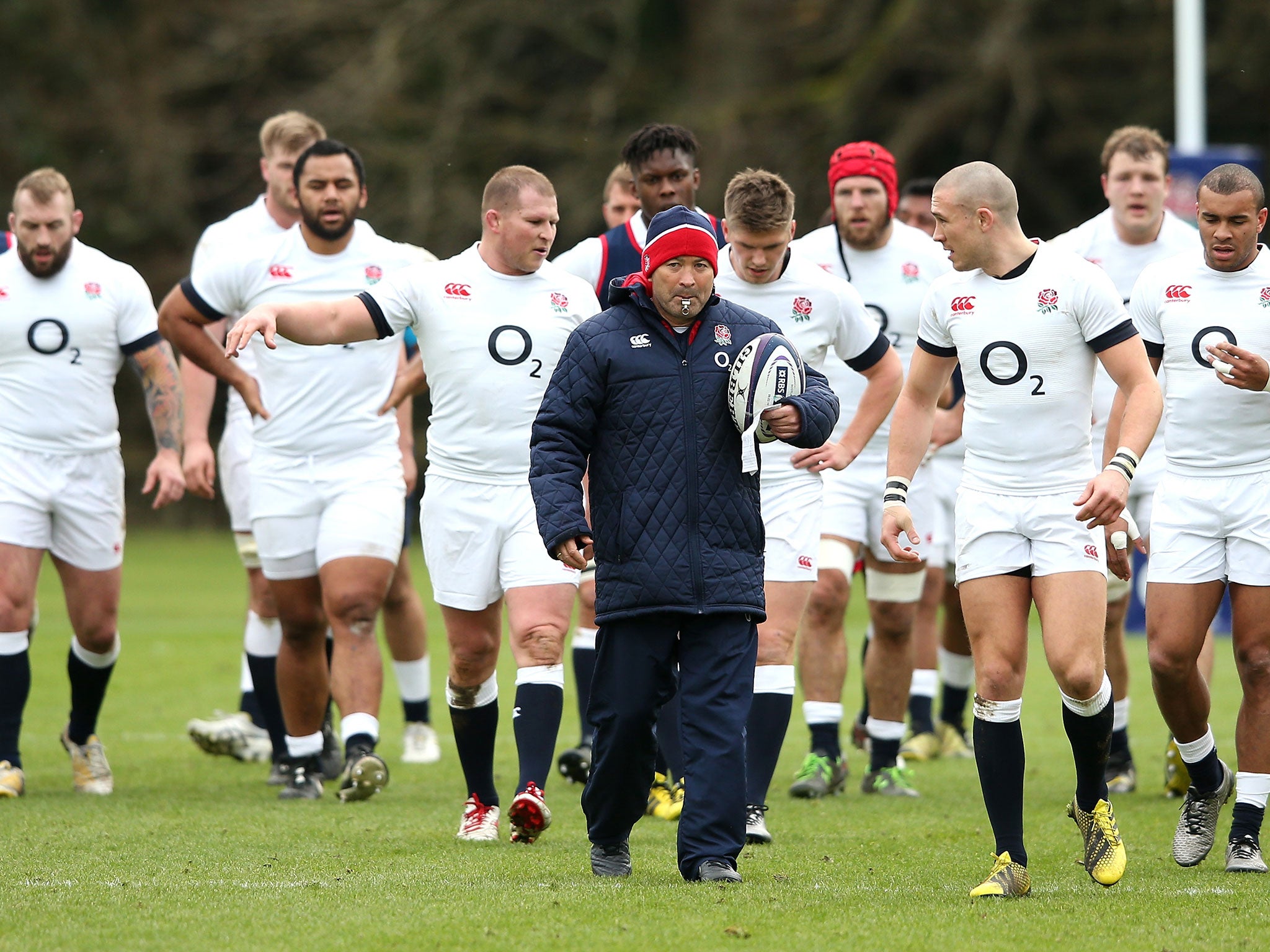 Eddie Jones, centre, the England head coach, leads his squad out for a training session at Pennyhill Park