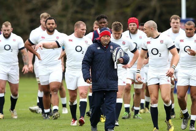 Eddie Jones, centre, the England head coach, leads his squad out for a training session at Pennyhill Park