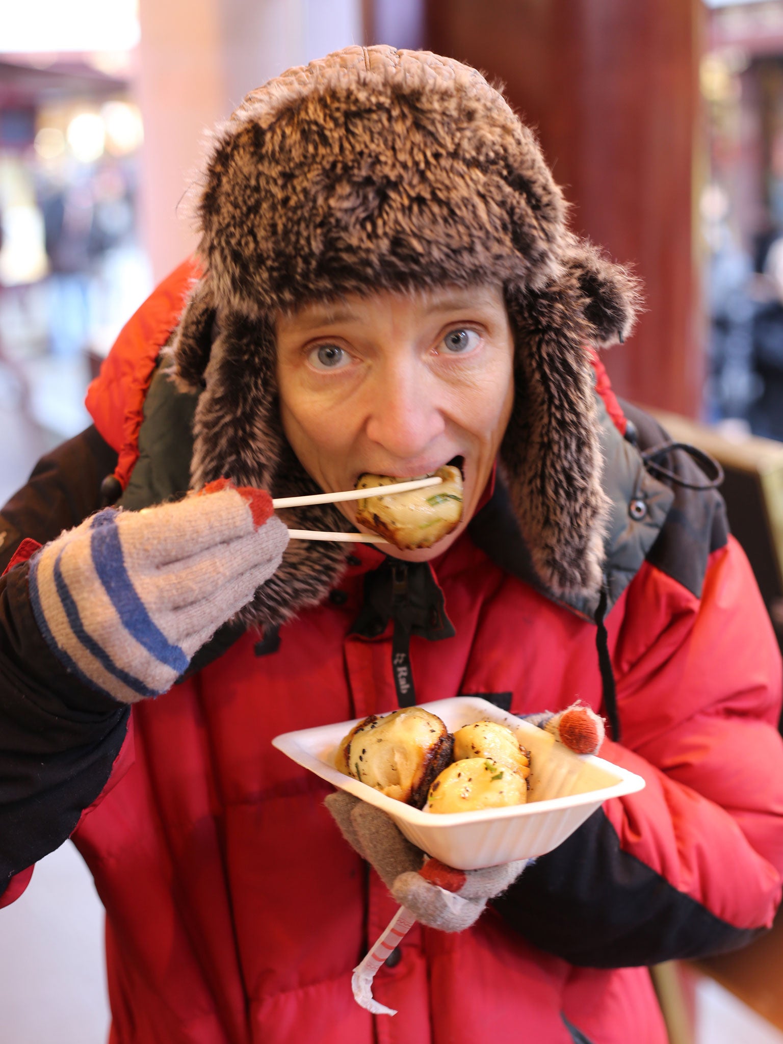 Cathy trying some street food in Shanghai, China