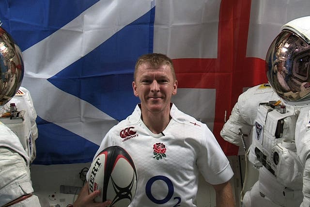 Tim Peake poses in his England shirt ahead of the Six Nations opener against Scotland