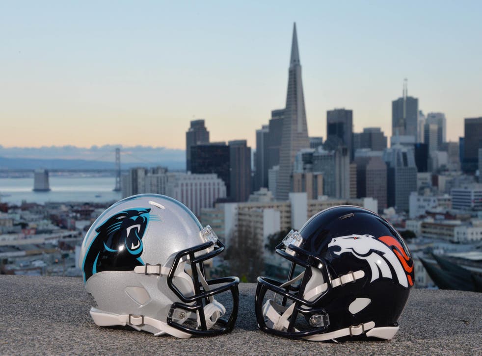 Carolina Panthers and Denver Broncos helmets with the San Francisco skyline and Bay Bridge as a backdrop