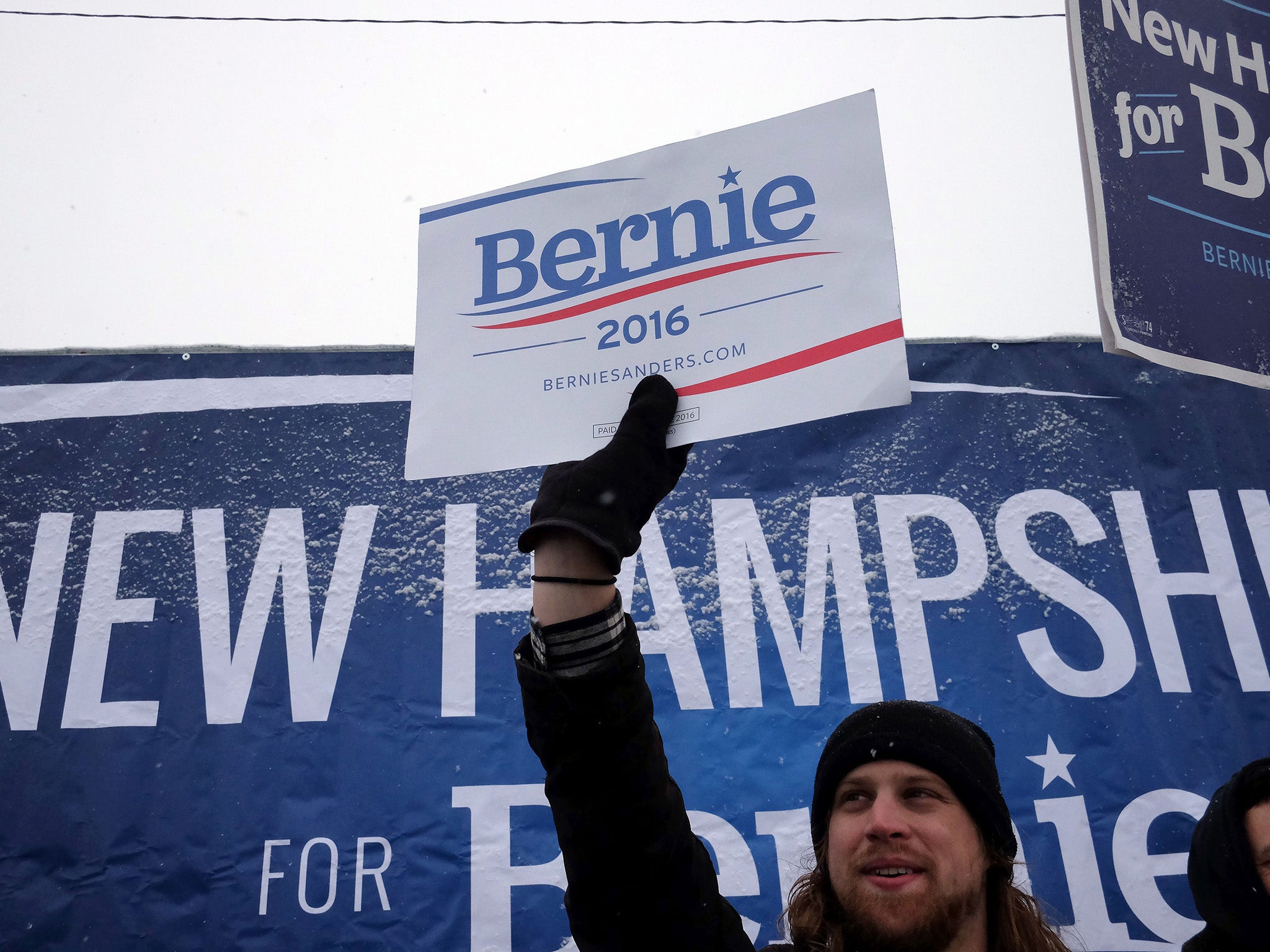 Supporters of US Democratic presidential candidate Bernie Sanders cheer on a street in Manchester, New Hampshire