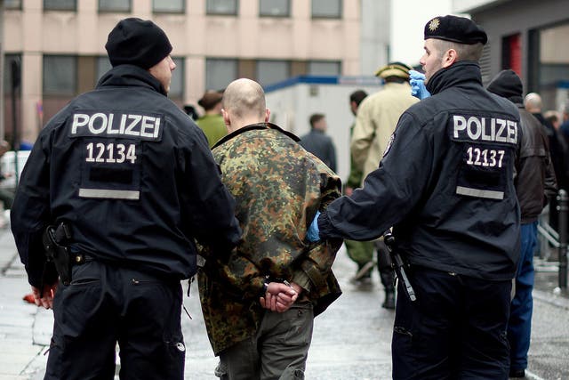 Police detain a man during the celebrations in Cologne