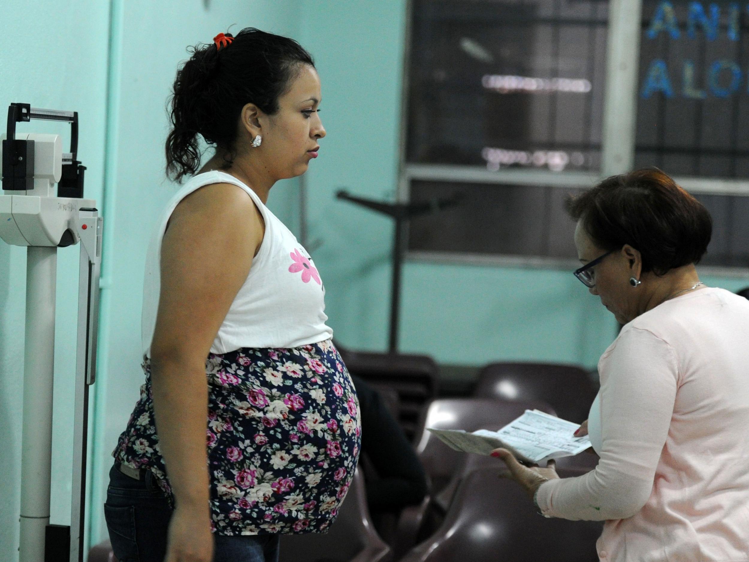 A pregnant woman is checked by a doctor at the 'Alonso Suazo' clinic in Tegucigalpa Getty