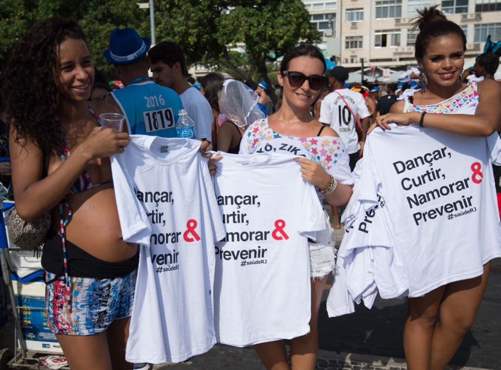T-shirts and pamphlets containing information about the Zika virus are distributed as part of a prevention campaign at Copacabana beach in Rio de Janeiro, Brazil