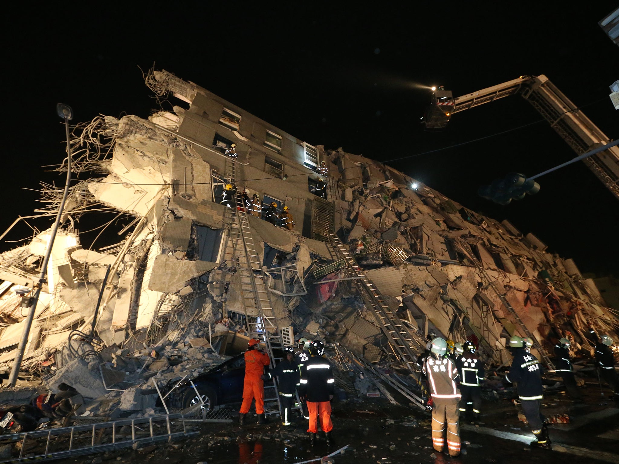 Rescue personnel at the site of collapsed building in Tainin, Taiwan
