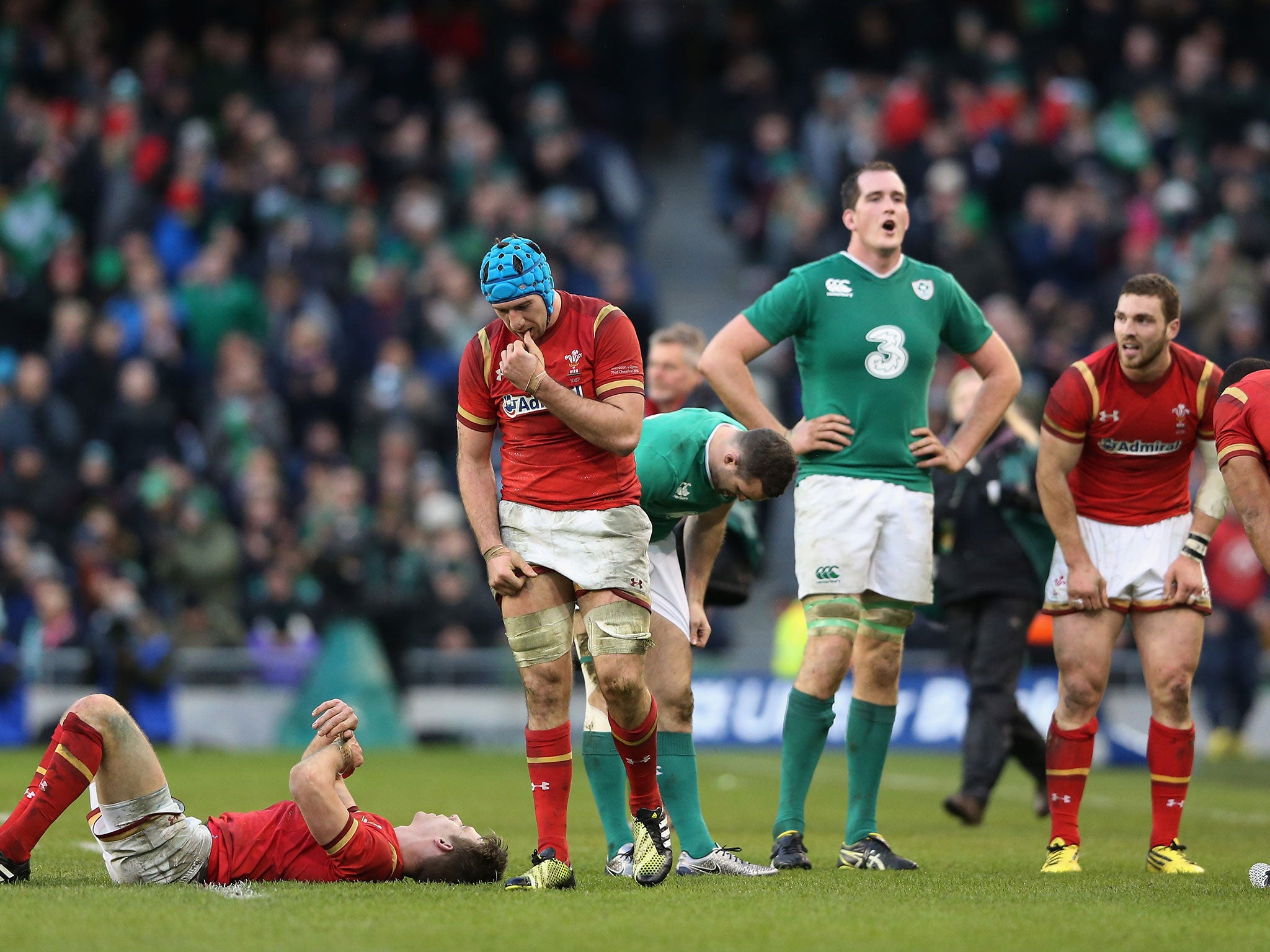 Irish and Welsh players react to the final whistle.