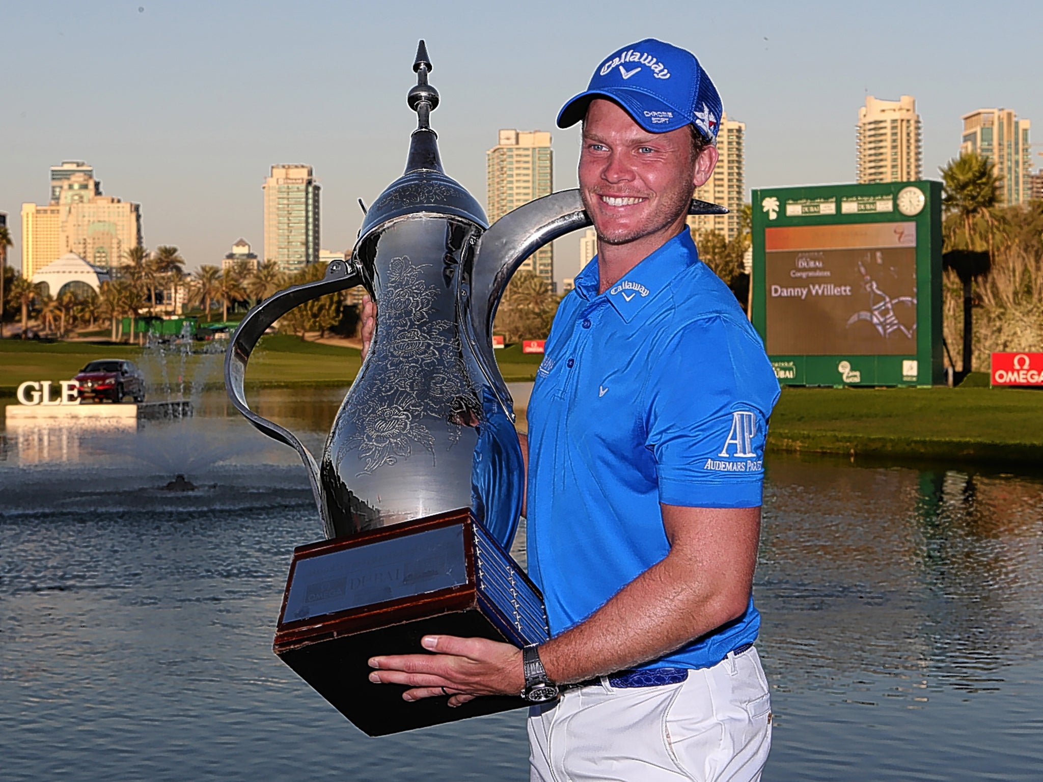 Danny Willett gets to grips with the trophy after his victory at the Dubai Desert Classic