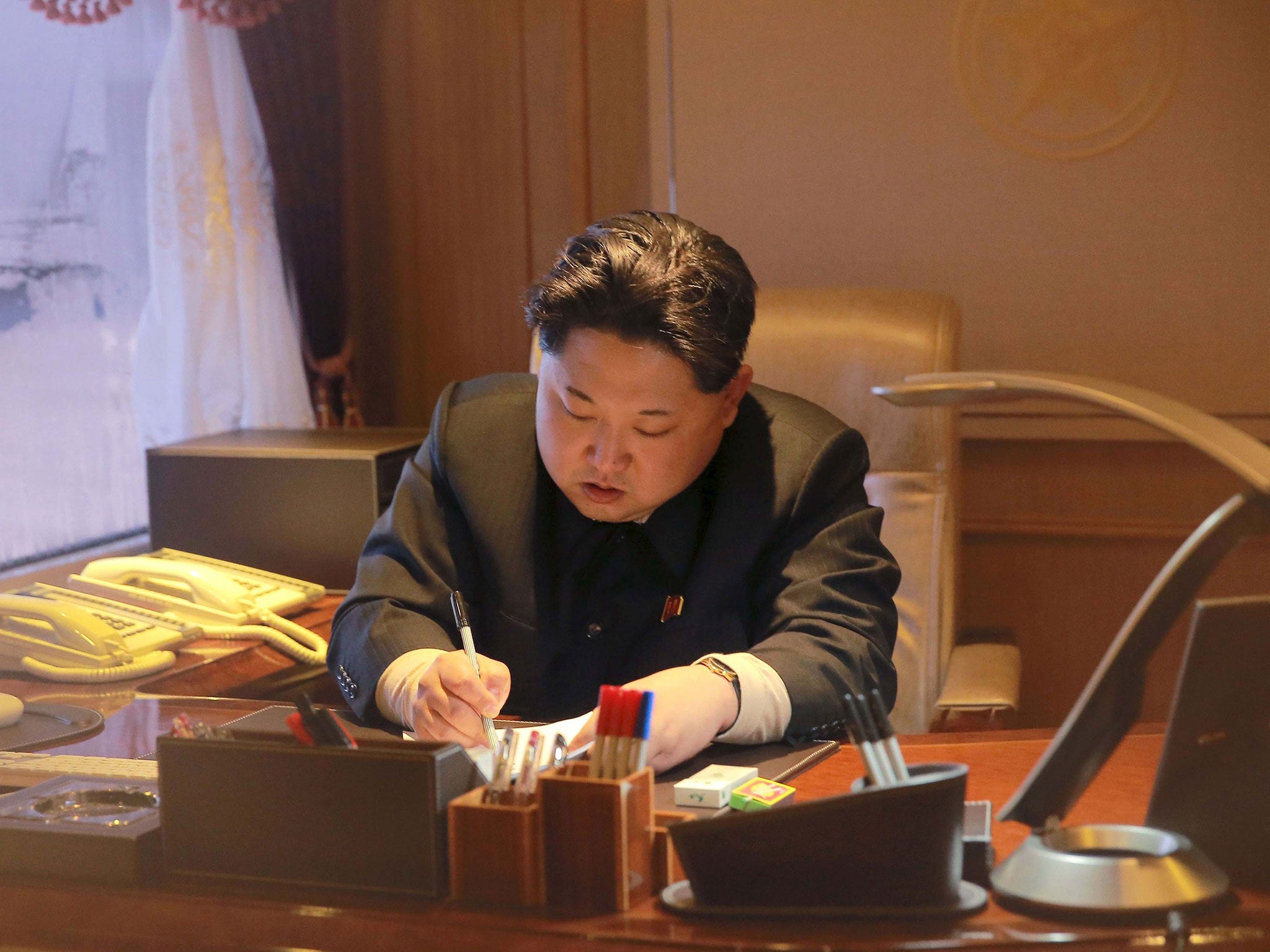 The most recent image of Kim Jong-un released by the North Korean government - purportly showing him signing off on a rocket launch