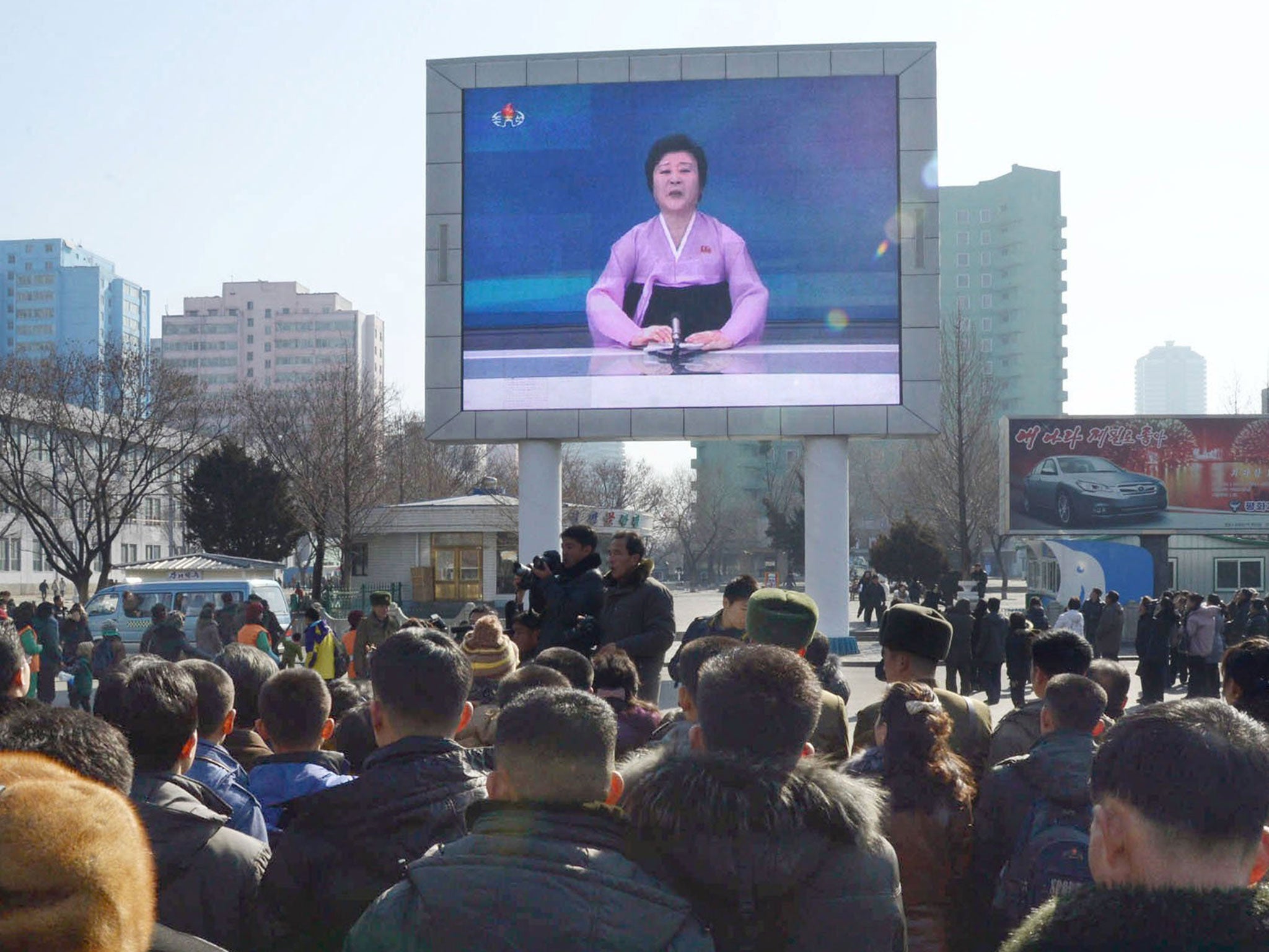 North Koreans watch news of the launch on a big screen in Pyongyang