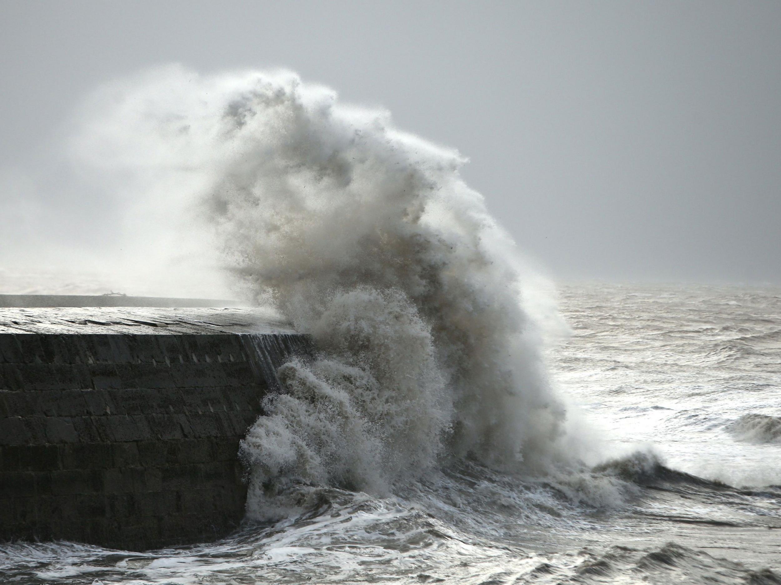 Waves crash against the harbour wall in Lyme Regis, Dorset as winds of nearly 100mph battered Britain after Storm Imogen slammed into the south coast