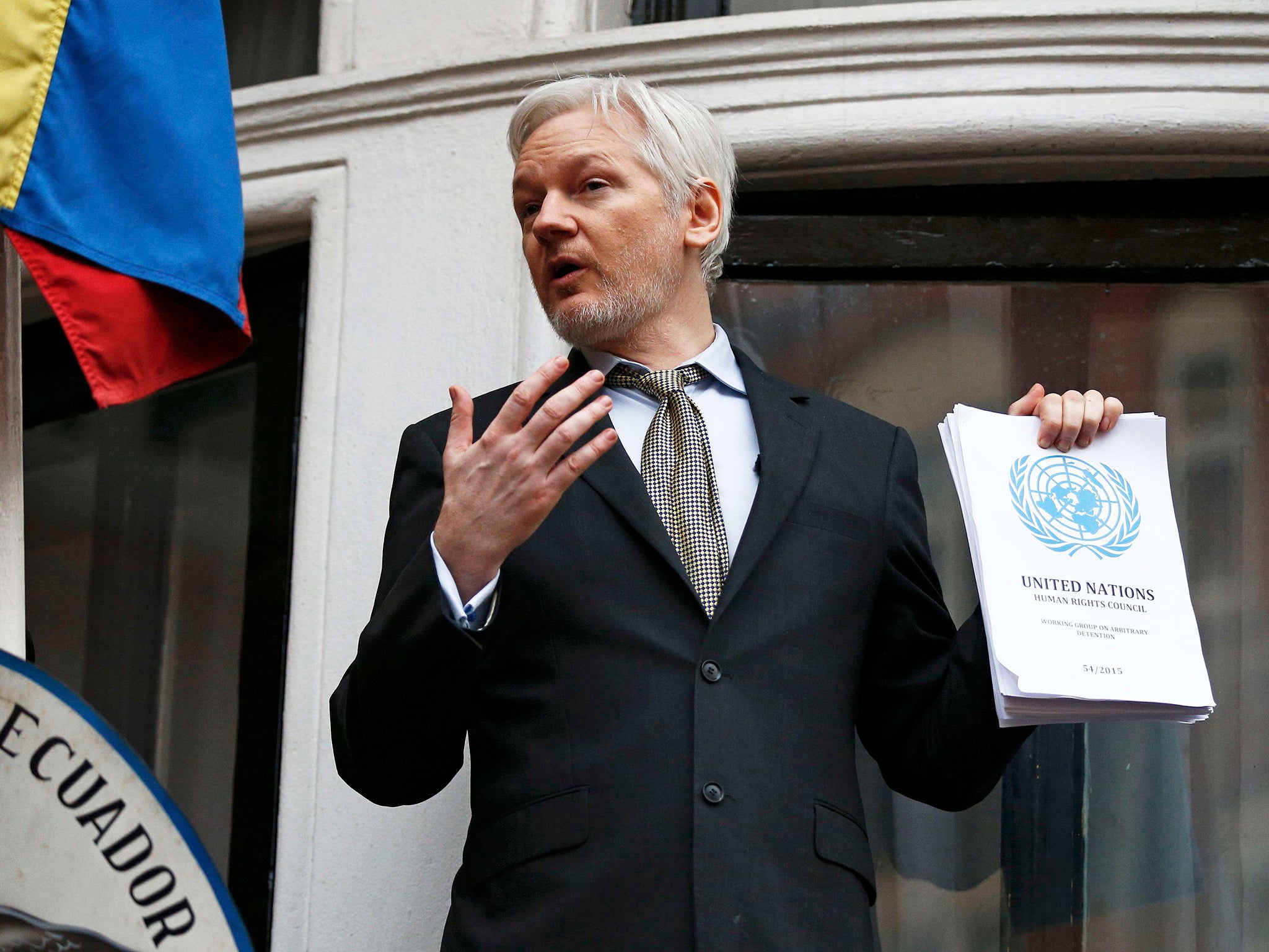 WikiLeaks founder Julian Assange holds a copy of a U.N. ruling as he makes a speech from the balcony of the Ecuadorian Embassy, in central London