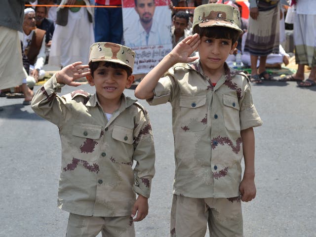 Yemeni children saluting during a military celebration in Sana'a