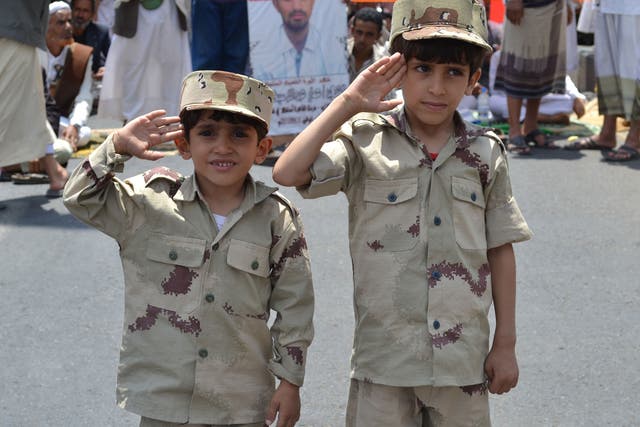 Yemeni children saluting during a military celebration in Sana'a