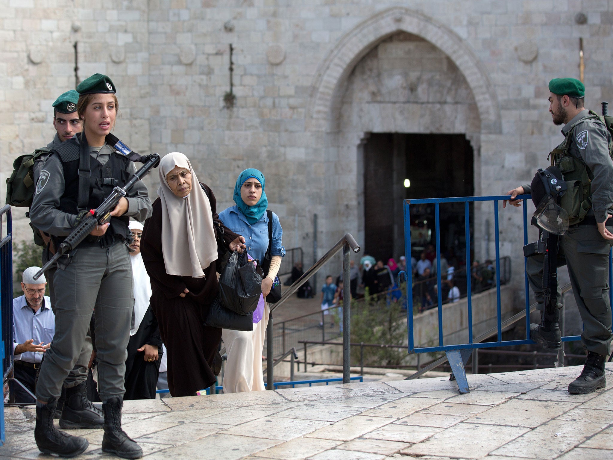 Palestinian women cross into Israel via the Damascus Gate in east Jerusalem