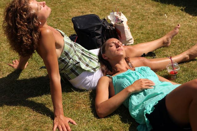 Spectators sunbathe at the Wimbledon Tennis Championships